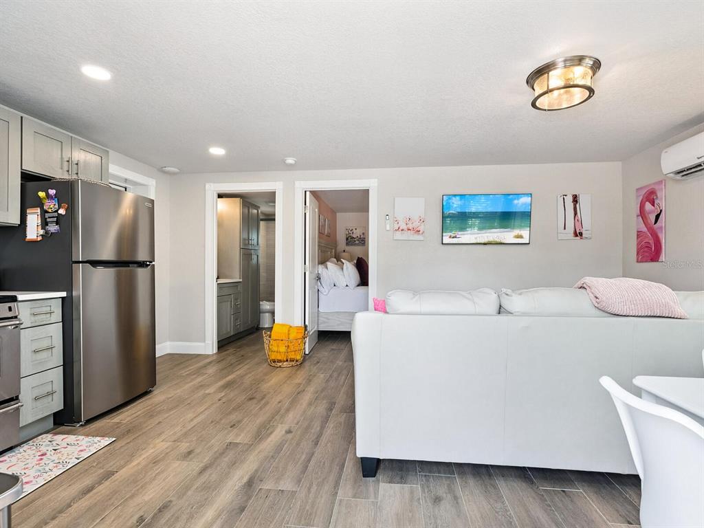 544 Canal Road Sarasota, FL 34242 - Photo 5 of 35 a living room with stainless steel appliances furniture a refrigerator and a kitchen view