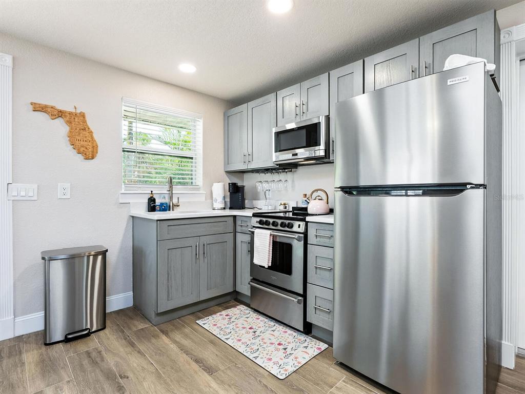 544 Canal Road Sarasota, FL 34242 - Photo 7 of 35 a kitchen with stainless steel appliances a refrigerator sink and microwave