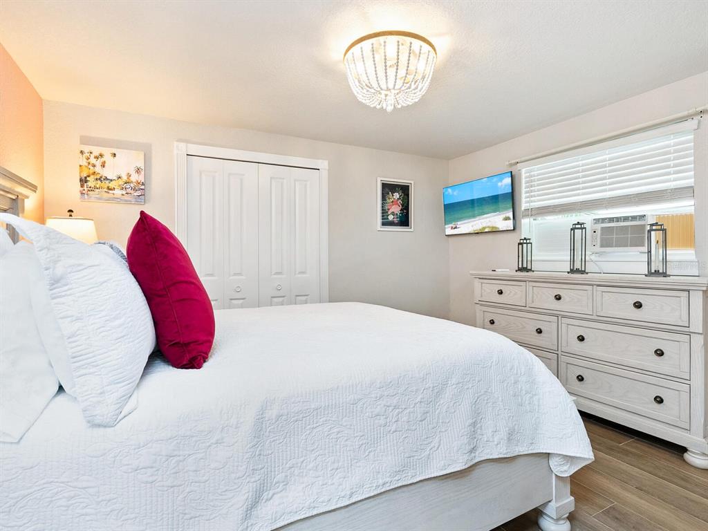 544 Canal Road Sarasota, FL 34242 - Photo 8 of 35 a bedroom with a bed and a chandelier