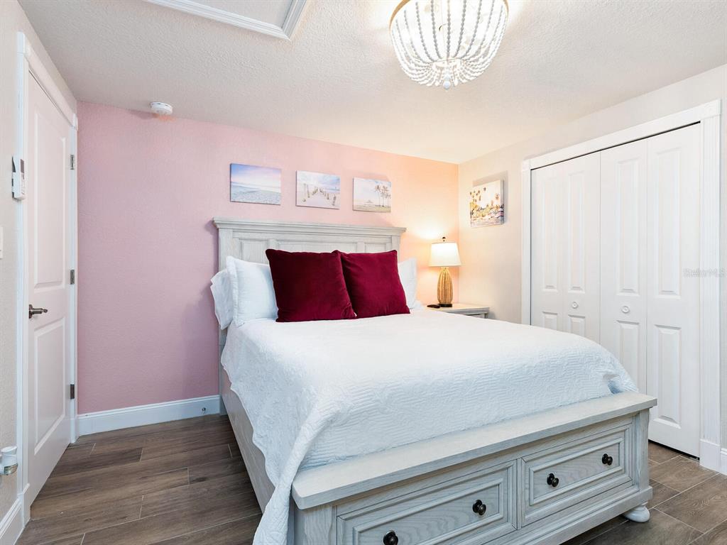 544 Canal Road Sarasota, FL 34242 - Photo 9 of 35 a bedroom with a bed and a chandelier