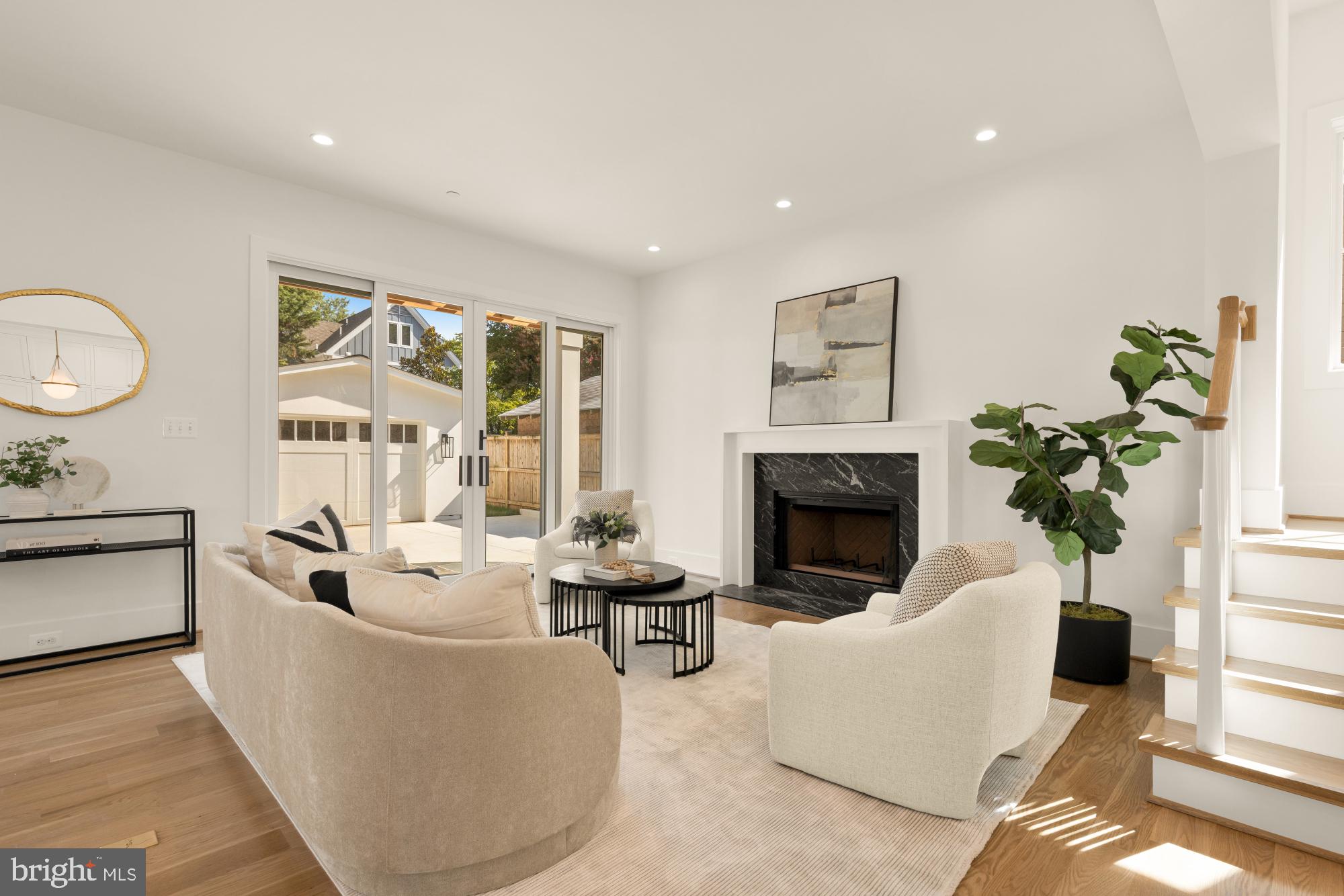4427 Ridge Street Chevy Chase, MD 20815 - Photo 11 of 42 a living room with furniture a fireplace and a potted plant