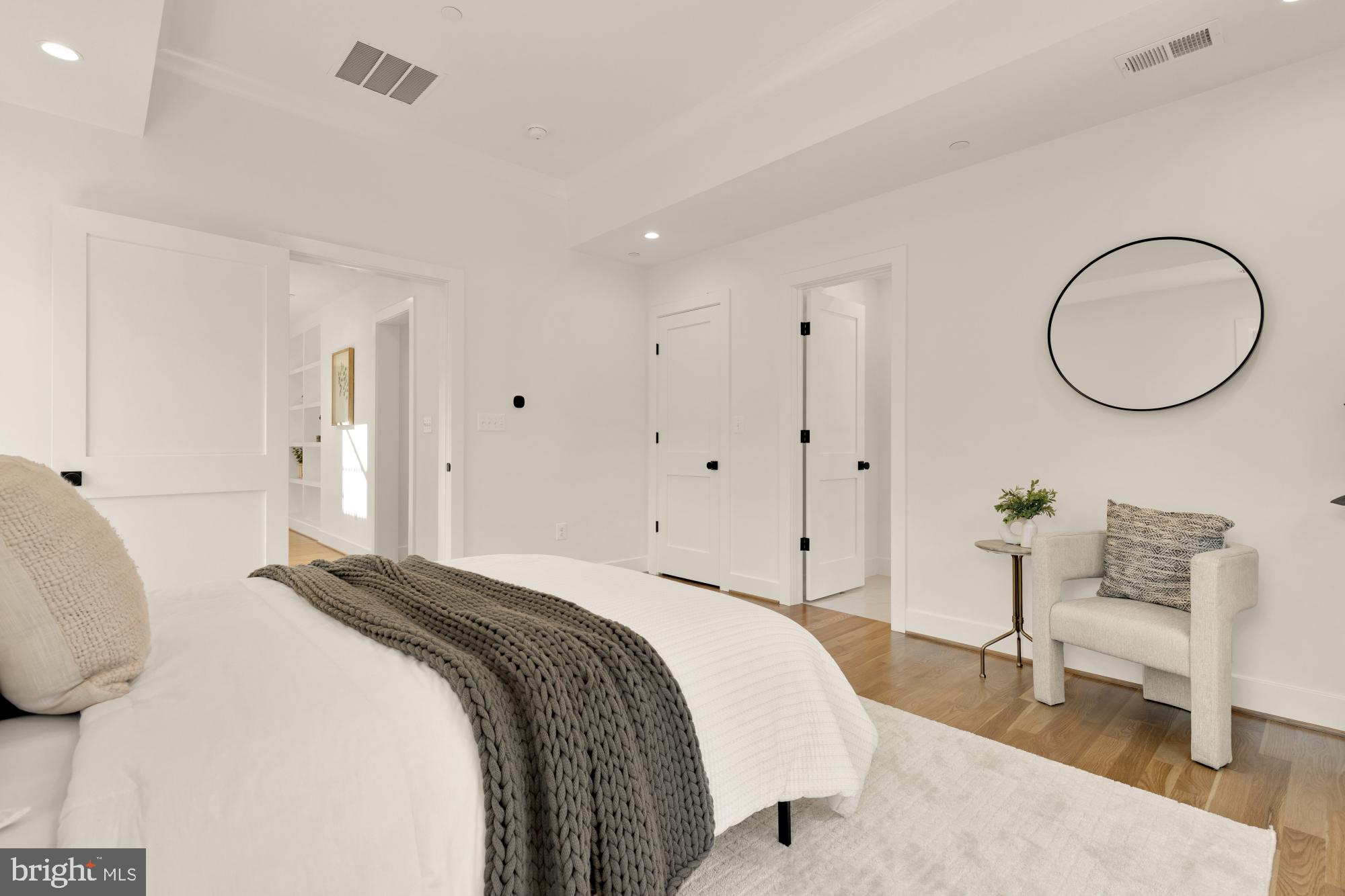 4427 Ridge Street Chevy Chase, MD 20815 - Photo 16 of 42 a bedroom with a bed a chair a lamp and a potted plant