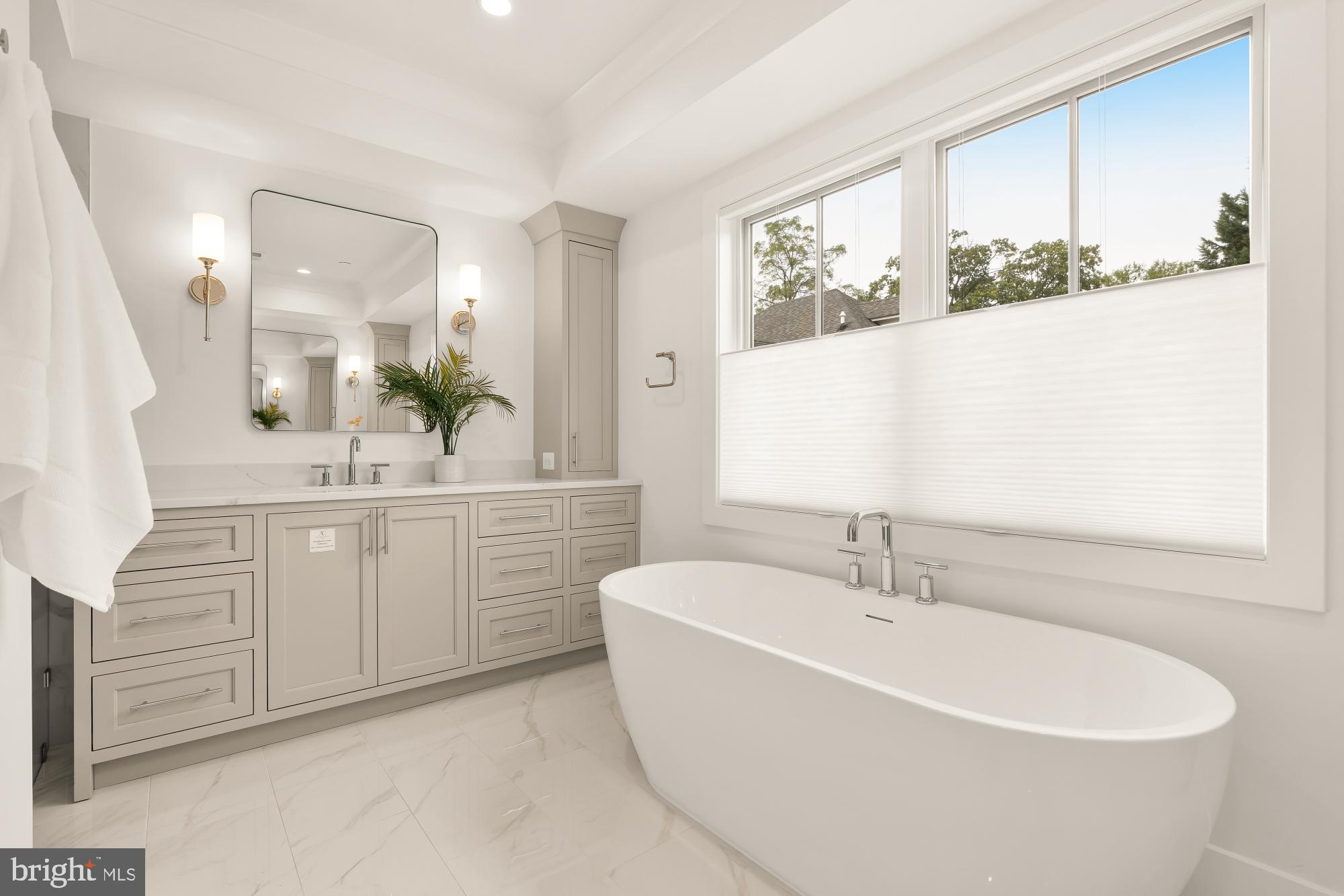 4427 Ridge Street Chevy Chase, MD 20815 - Photo 17 of 42 a bathroom with a bathtub a double vanity sink and mirror