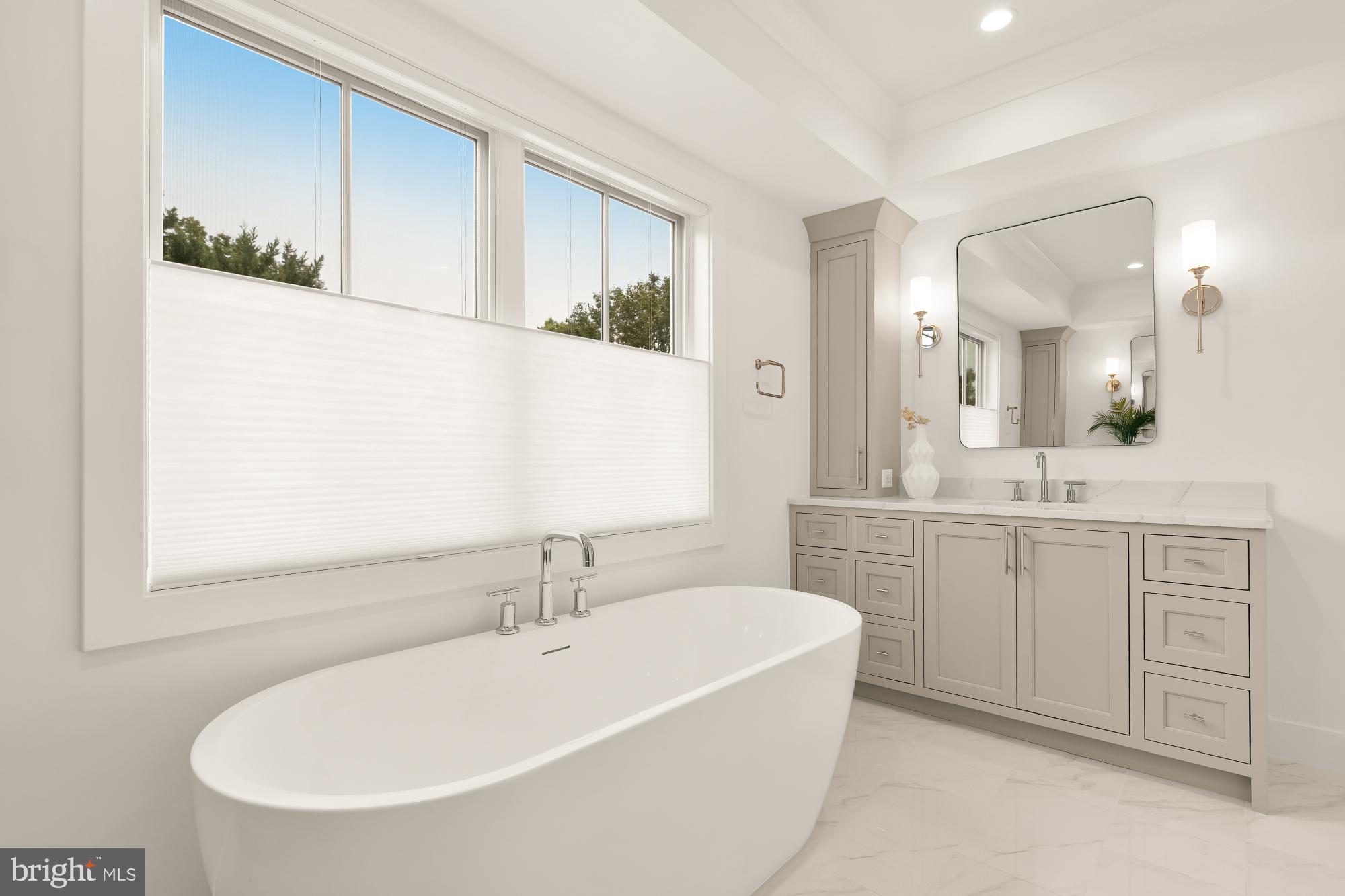 4427 Ridge Street Chevy Chase, MD 20815 - Photo 18 of 42 a bathroom with a tub a sink and mirror