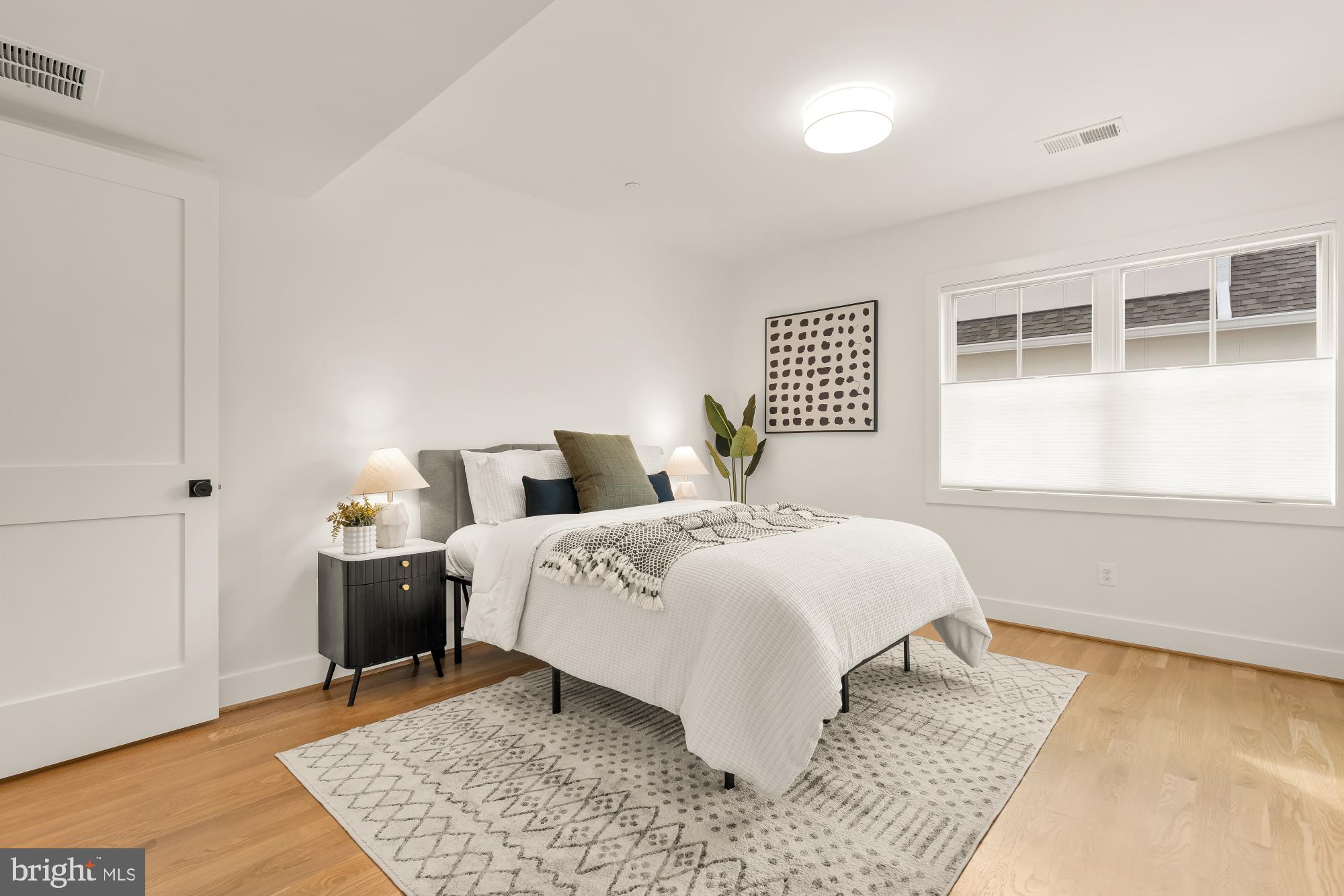 4427 Ridge Street Chevy Chase, MD 20815 - Photo 20 of 42 a bedroom with a bed and wooden floor