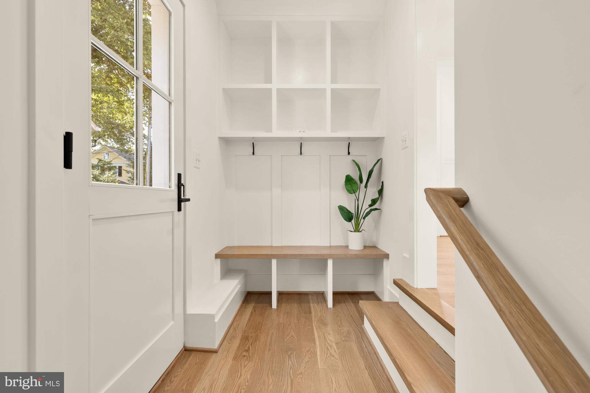 4427 Ridge Street Chevy Chase, MD 20815 - Photo 2 of 42 a view of a hallway with wooden floor and a potted plant