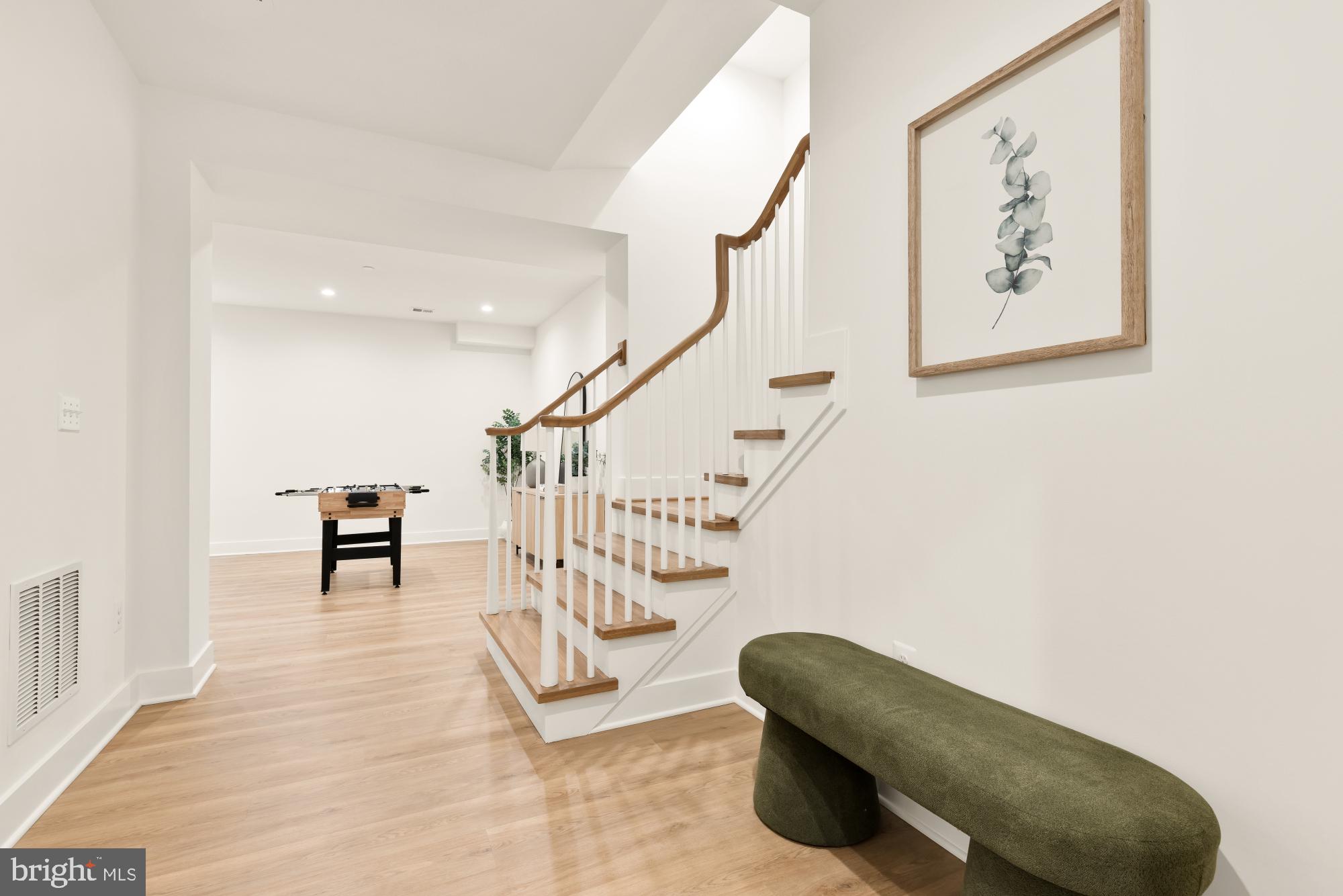 4427 Ridge Street Chevy Chase, MD 20815 - Photo 29 of 42 a hallway with stairs and a potted plant