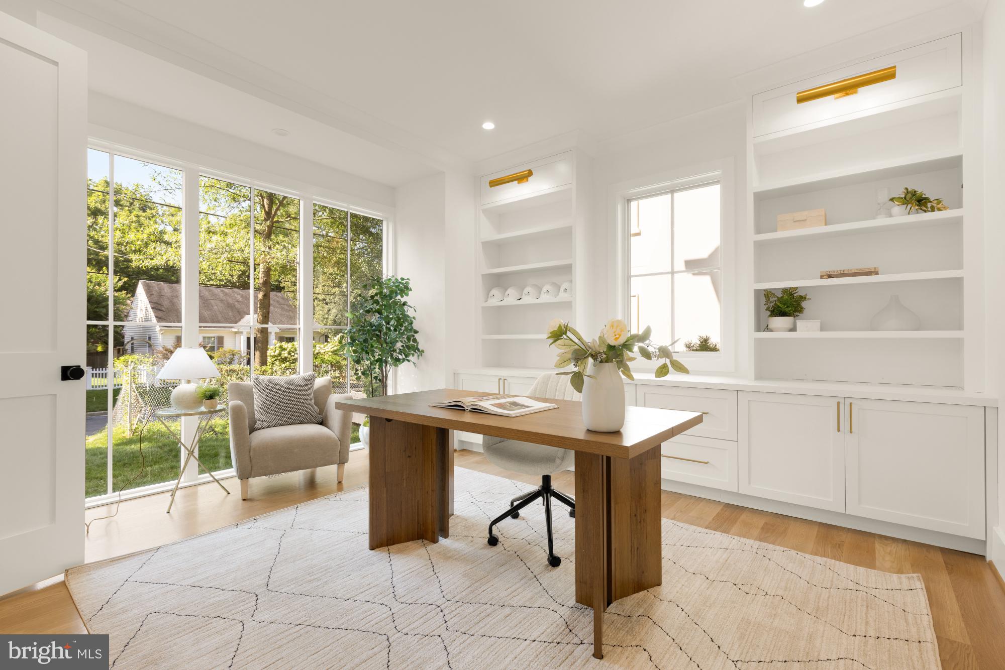 4427 Ridge Street Chevy Chase, MD 20815 - Photo 3 of 42 a living room with furniture a large window and a table