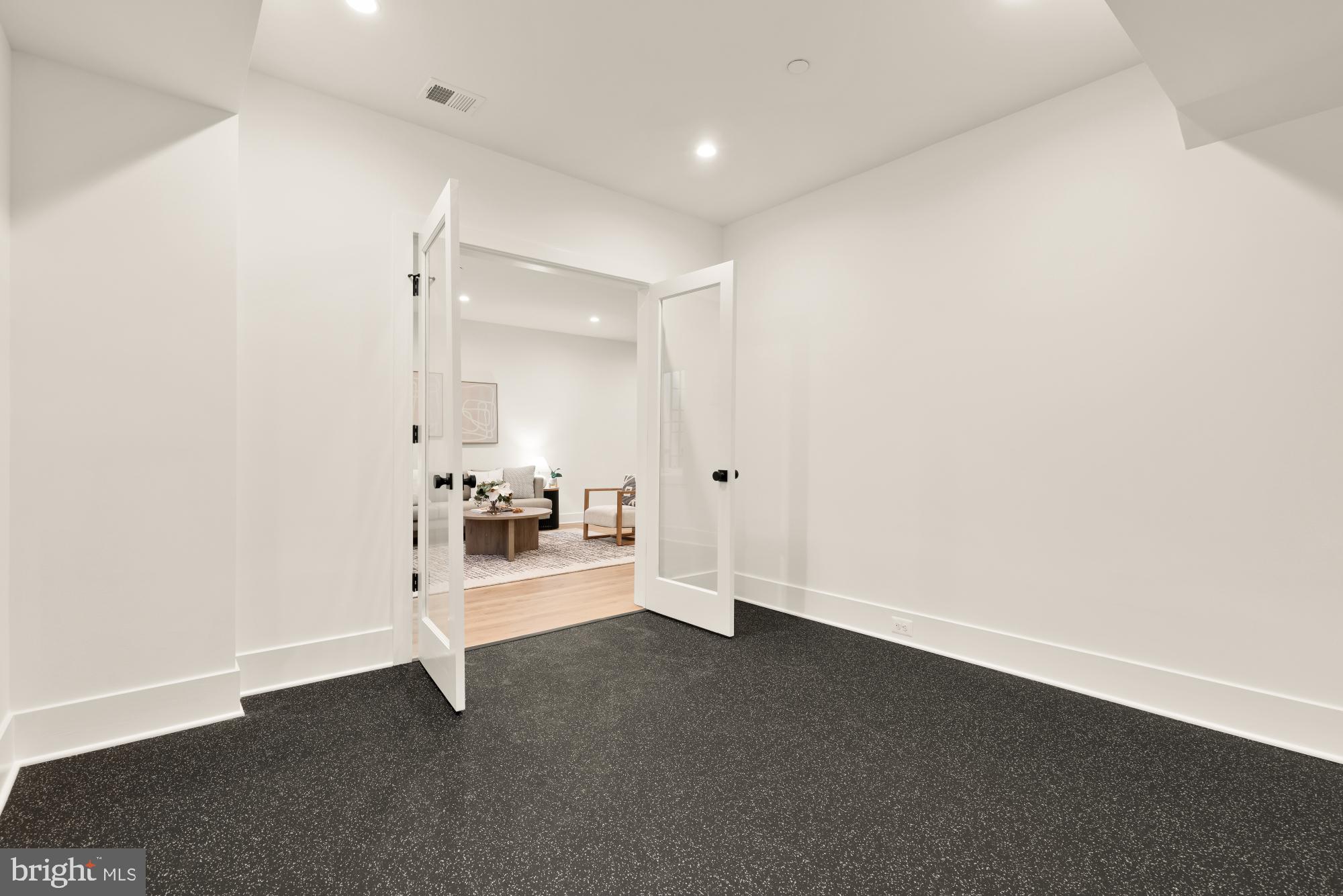 4427 Ridge Street Chevy Chase, MD 20815 - Photo 35 of 42 an empty room with a cabinet and mirrors