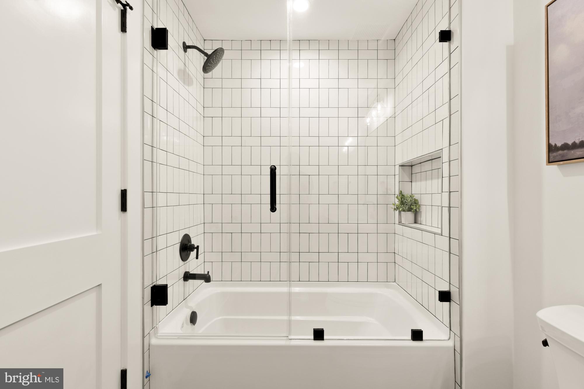 4427 Ridge Street Chevy Chase, MD 20815 - Photo 37 of 42 a bathroom with a bathtub and a shower