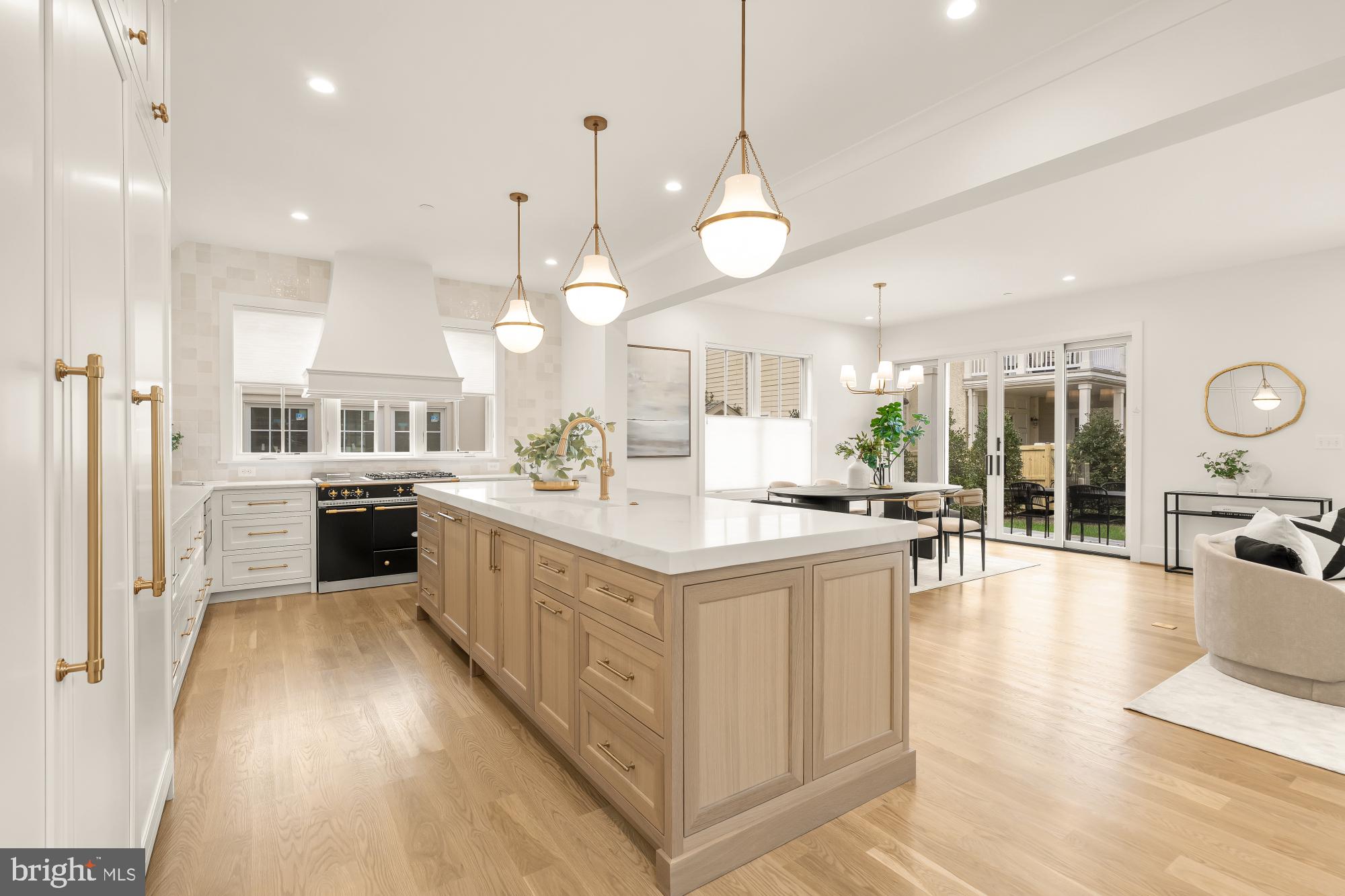 4427 Ridge Street Chevy Chase, MD 20815 - Photo 4 of 42 a large kitchen with stainless steel appliances kitchen island granite countertop a large counter top a sink a stove and a refrigerator