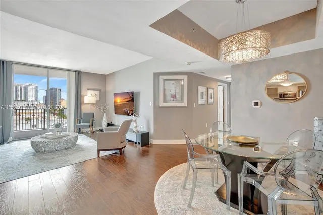 a living room with furniture and a chandelier