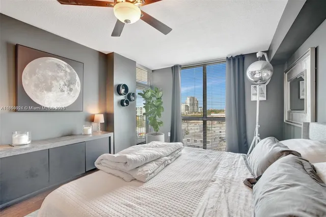 a bedroom with a large bed and a chandelier