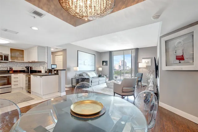a living room with furniture a dining table and kitchen view