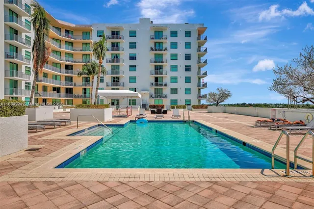 a view of a swimming pool and lounge chair