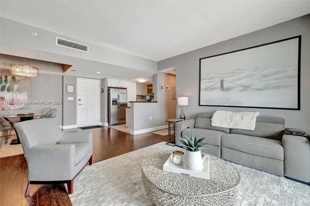a living room with furniture and a dining table