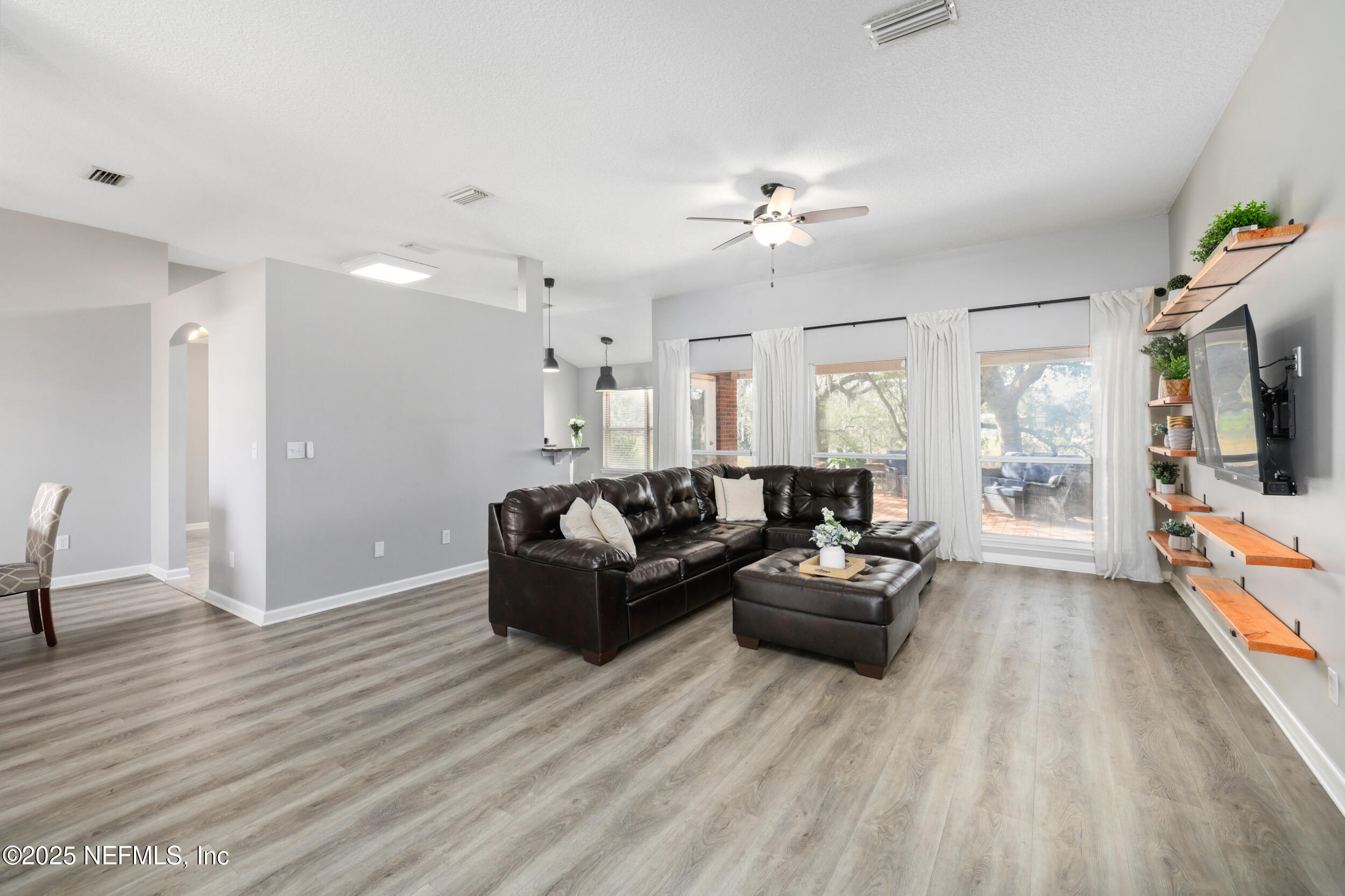 2948 Captiva Bluff Road South Jacksonville, FL 32226 - Photo 15 of 46 a living room with furniture and a flat screen tv