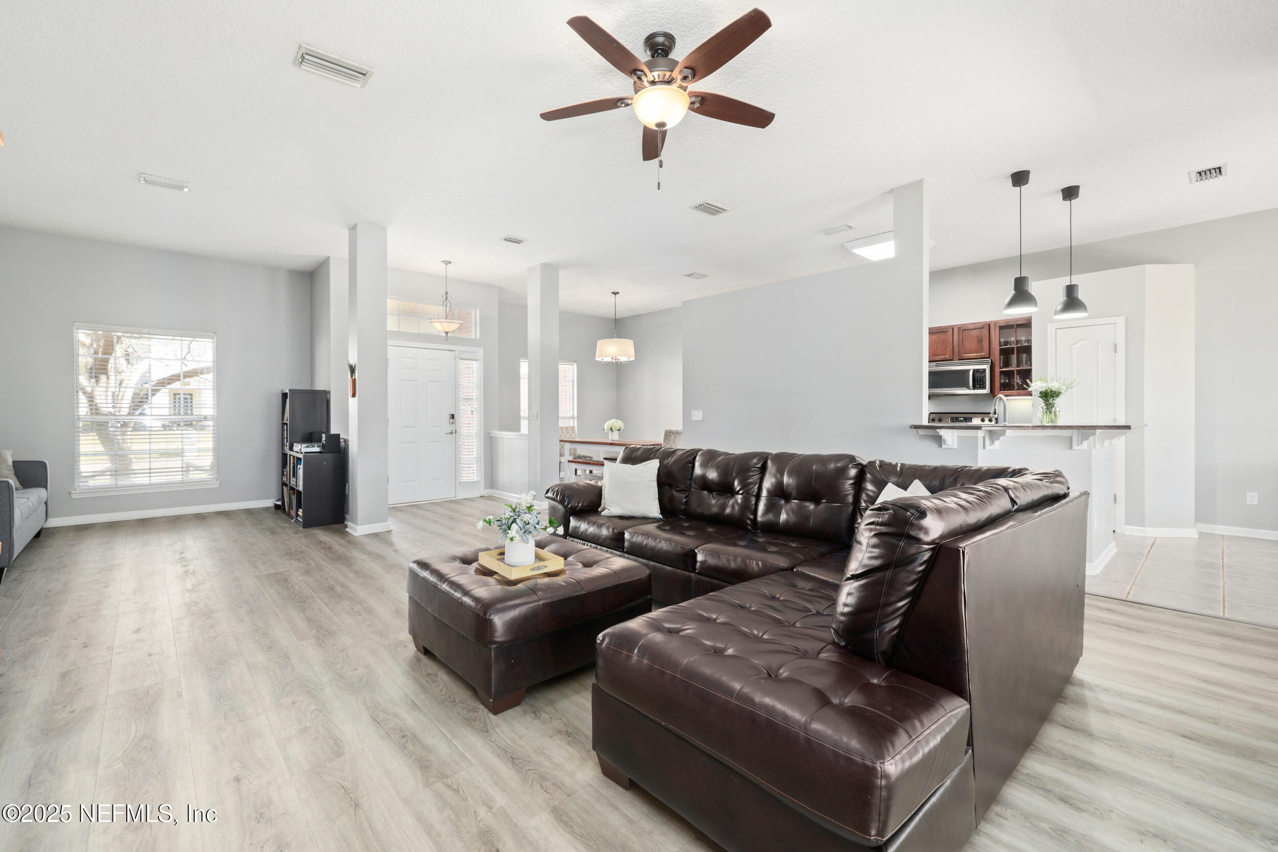 2948 Captiva Bluff Road South Jacksonville, FL 32226 - Photo 16 of 46 a living room with furniture and a wooden floor