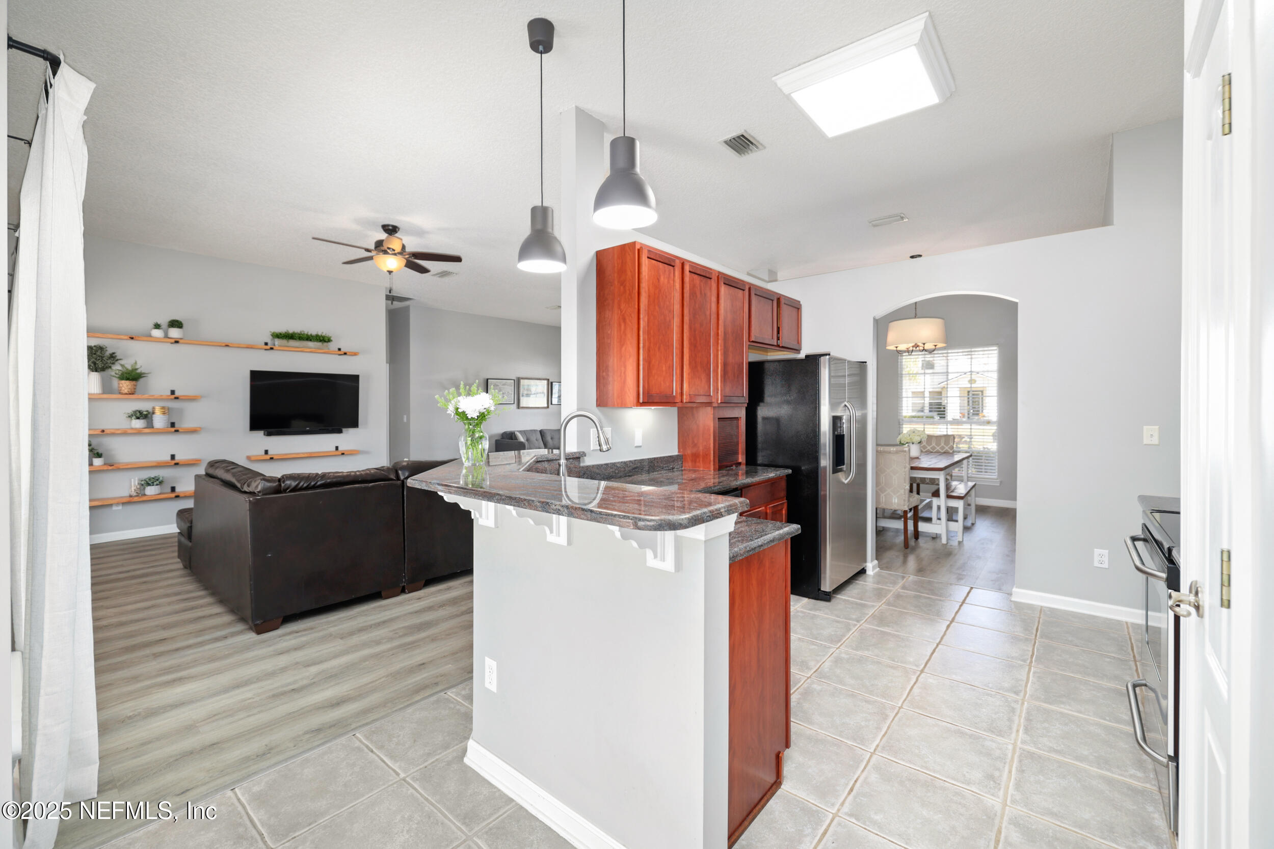 2948 Captiva Bluff Road South Jacksonville, FL 32226 - Photo 18 of 46 a living room with furniture a flat screen tv and kitchen view