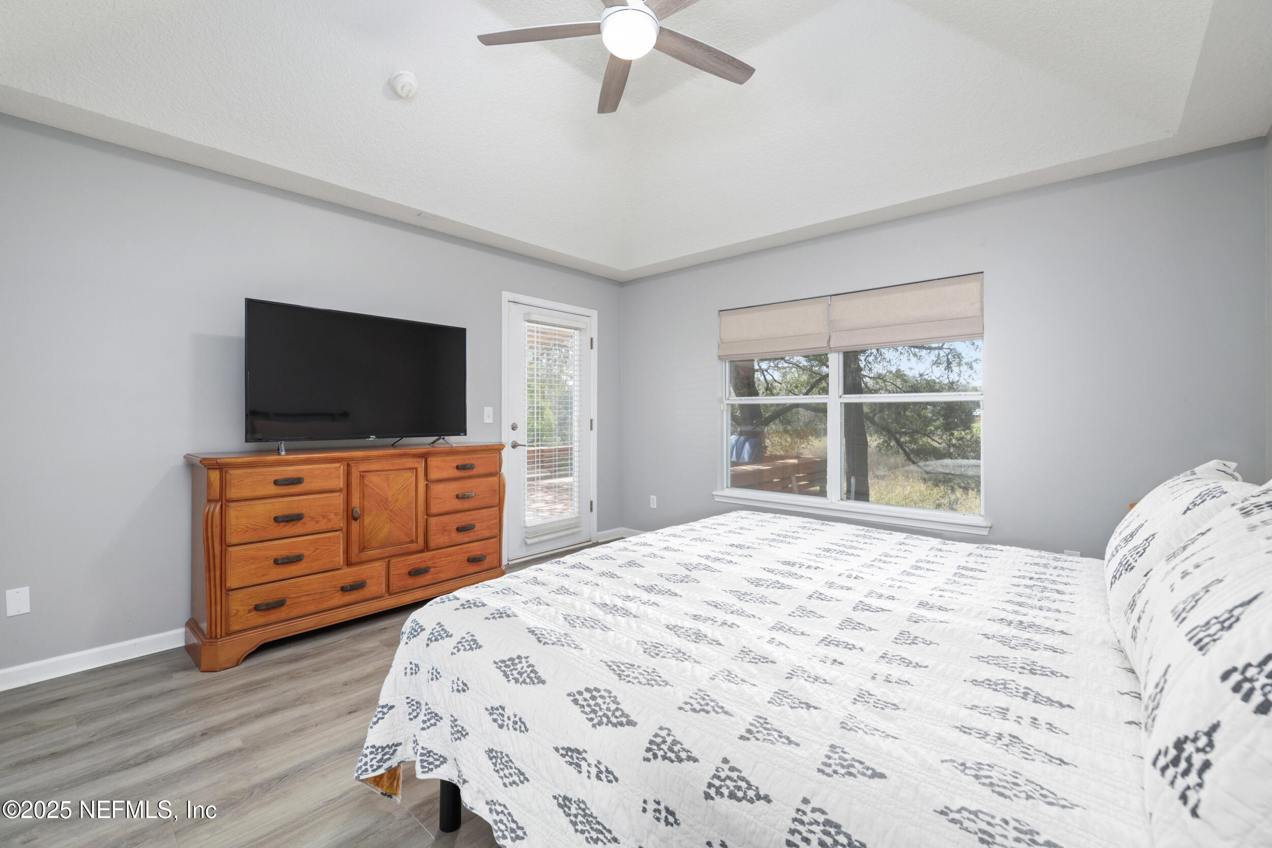 2948 Captiva Bluff Road South Jacksonville, FL 32226 - Photo 23 of 46 a bedroom with a bed and flat screen tv