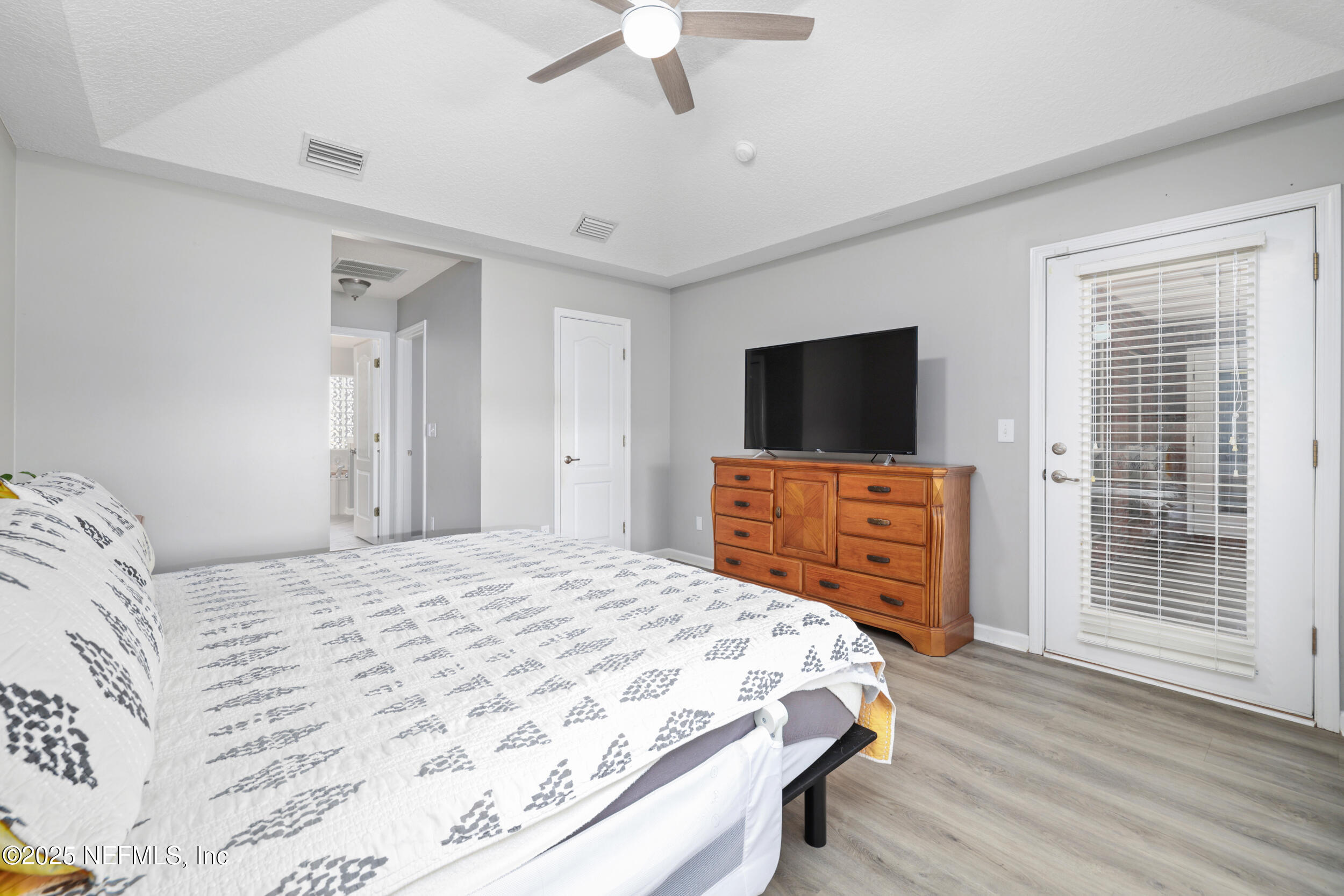 2948 Captiva Bluff Road South Jacksonville, FL 32226 - Photo 25 of 46 a bedroom with a bed and a flat screen tv