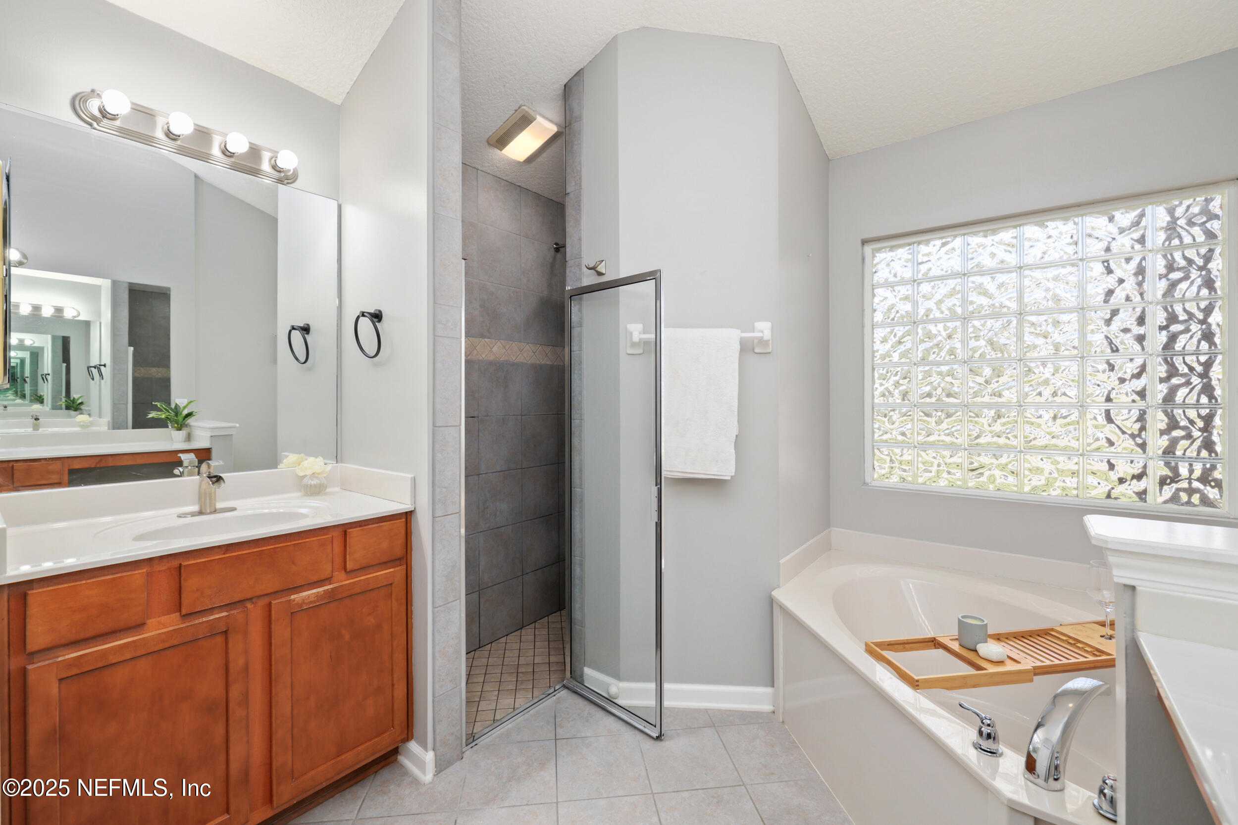 2948 Captiva Bluff Road South Jacksonville, FL 32226 - Photo 27 of 46 a bathroom with a tub sink and mirror