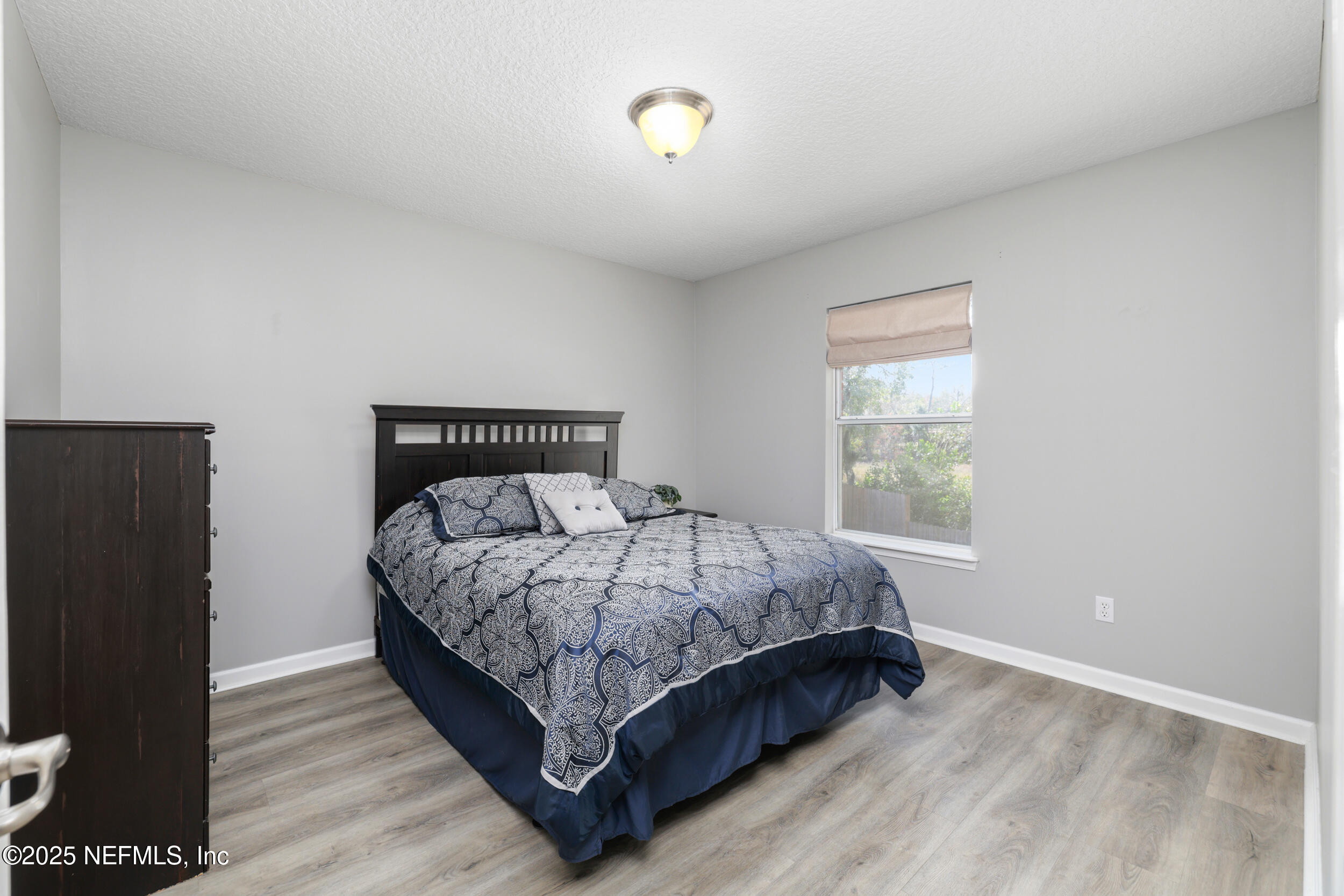 2948 Captiva Bluff Road South Jacksonville, FL 32226 - Photo 29 of 46 a bed sitting in a bedroom next to a window