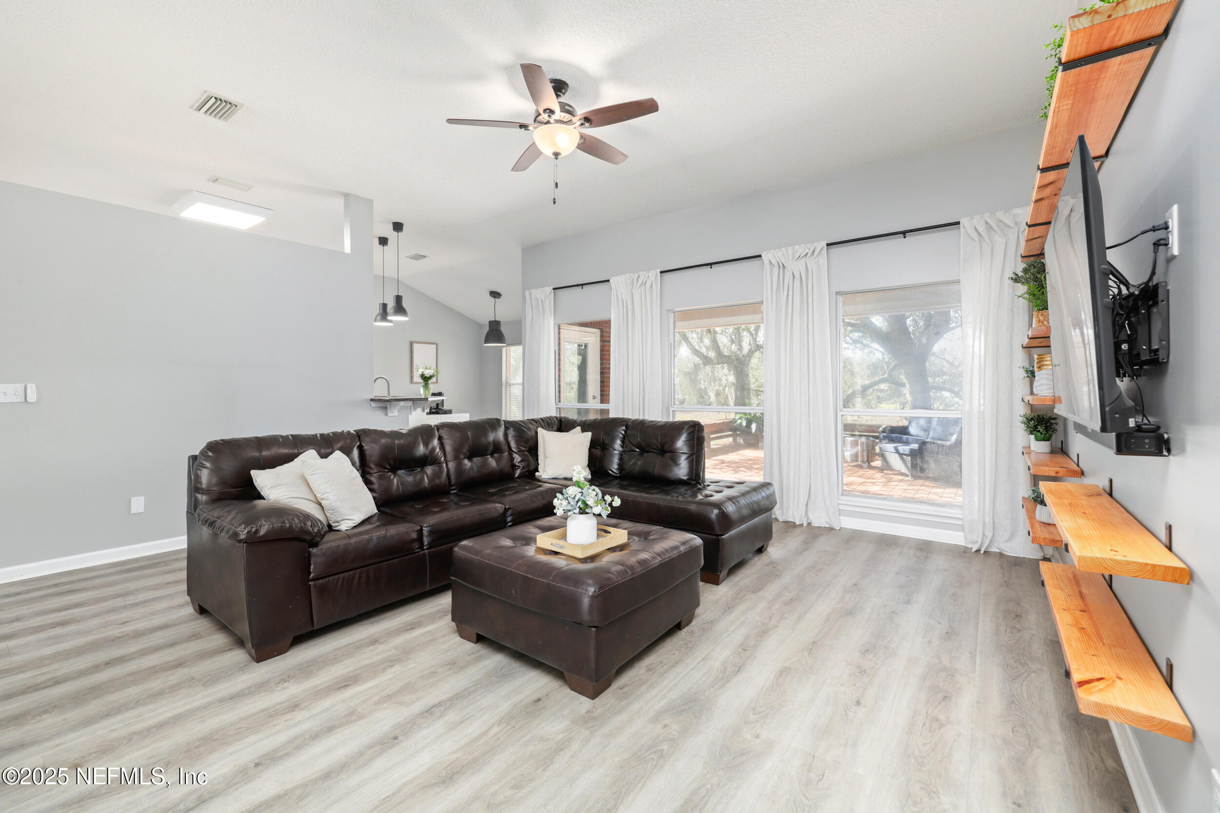 2948 Captiva Bluff Road South Jacksonville, FL 32226 - Photo 3 of 46 a living room with furniture a flat screen tv and a fireplace