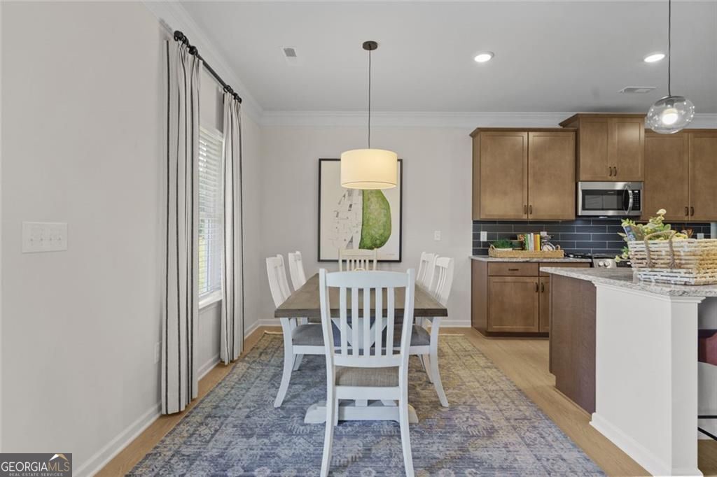 156 Saddle Ridge Trail Calhoun, GA 30701 - Photo 11 of 45 a kitchen with kitchen island granite countertop a sink cabinets and window