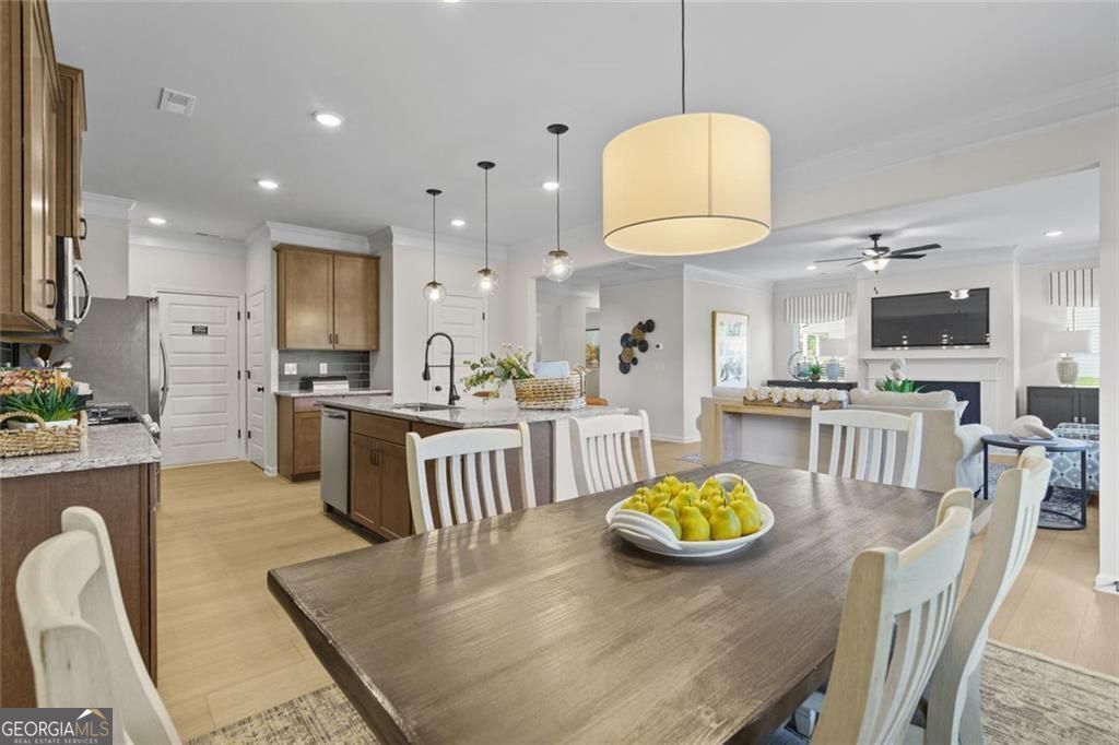 156 Saddle Ridge Trail Calhoun, GA 30701 - Photo 12 of 45 a kitchen with stainless steel appliances granite countertop a stove a refrigerator a kitchen island a stove and white cabinets