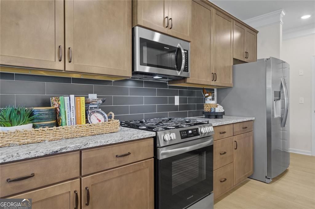 156 Saddle Ridge Trail Calhoun, GA 30701 - Photo 15 of 45 a kitchen with granite countertop cabinets stainless steel appliances and wooden floor