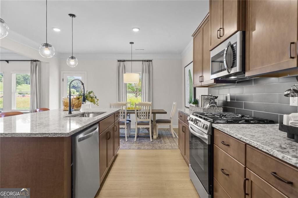156 Saddle Ridge Trail Calhoun, GA 30701 - Photo 17 of 45 a kitchen with stainless steel appliances granite countertop a stove a sink and a microwave