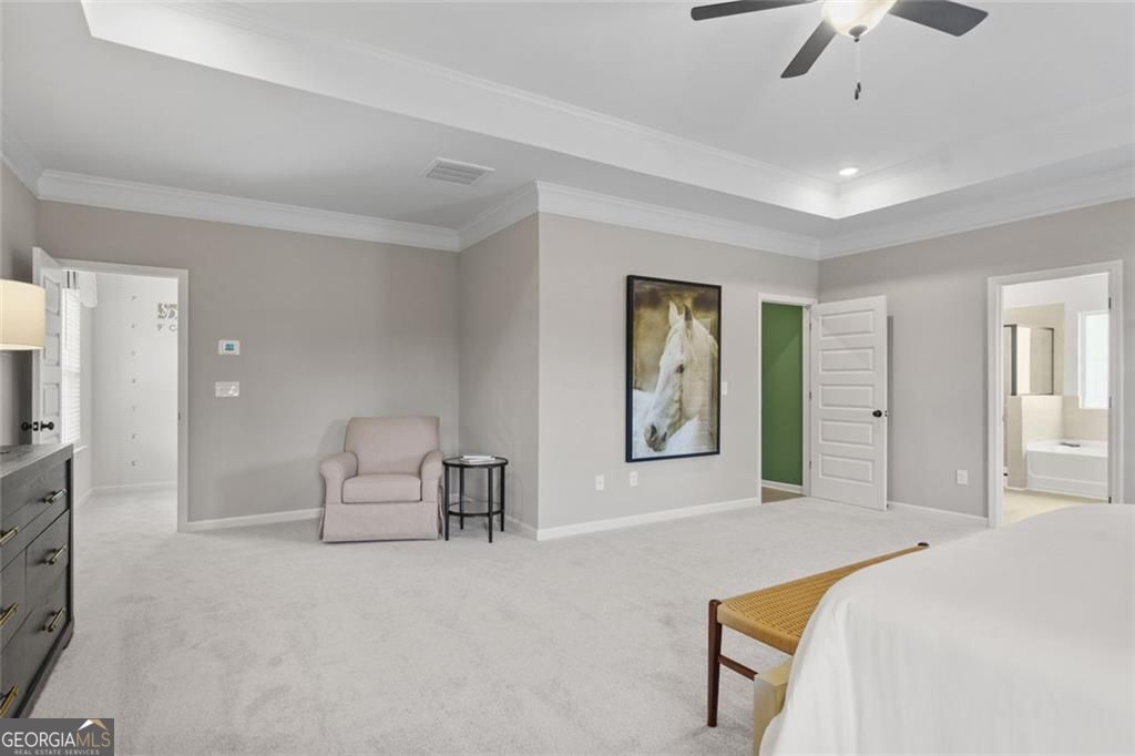 156 Saddle Ridge Trail Calhoun, GA 30701 - Photo 28 of 45 a spacious bedroom with a bed a couch and a chandelier