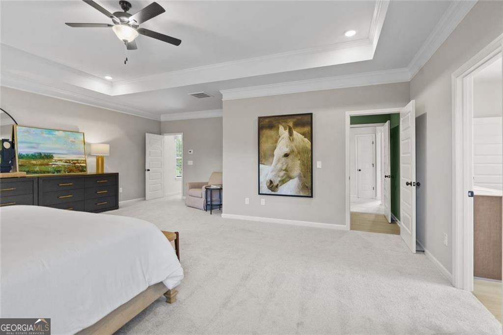 156 Saddle Ridge Trail Calhoun, GA 30701 - Photo 30 of 45 a spacious bedroom with a bed and a chandelier