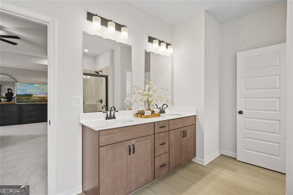 156 Saddle Ridge Trail Calhoun, GA 30701 - Photo 33 of 45 a bathroom with a double vanity sink a mirror and a shower