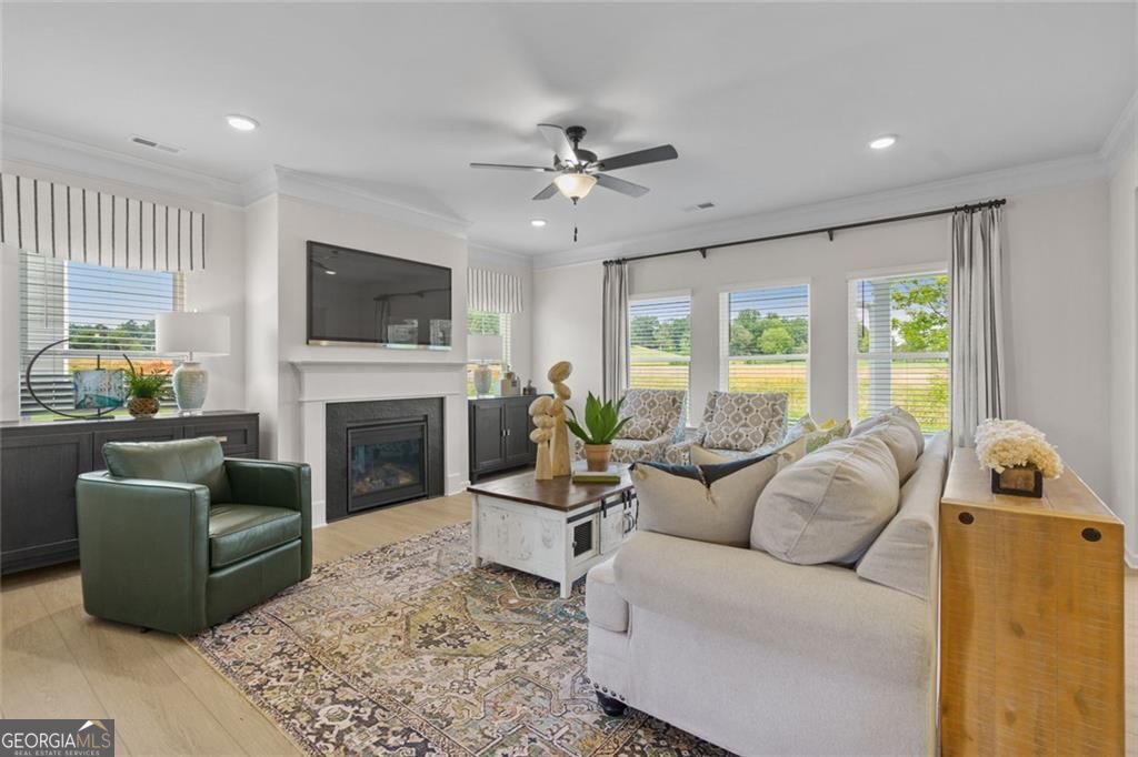 156 Saddle Ridge Trail Calhoun, GA 30701 - Photo 4 of 45 a living room with furniture a fireplace and a flat screen tv