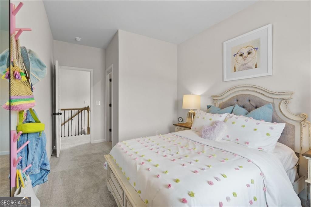 156 Saddle Ridge Trail Calhoun, GA 30701 - Photo 43 of 45 a bedroom with a bed a painting on the wall and a lamp