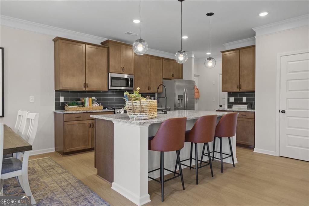 156 Saddle Ridge Trail Calhoun, GA 30701 - Photo 10 of 45 a kitchen with kitchen island granite countertop wooden cabinets and a refrigerator