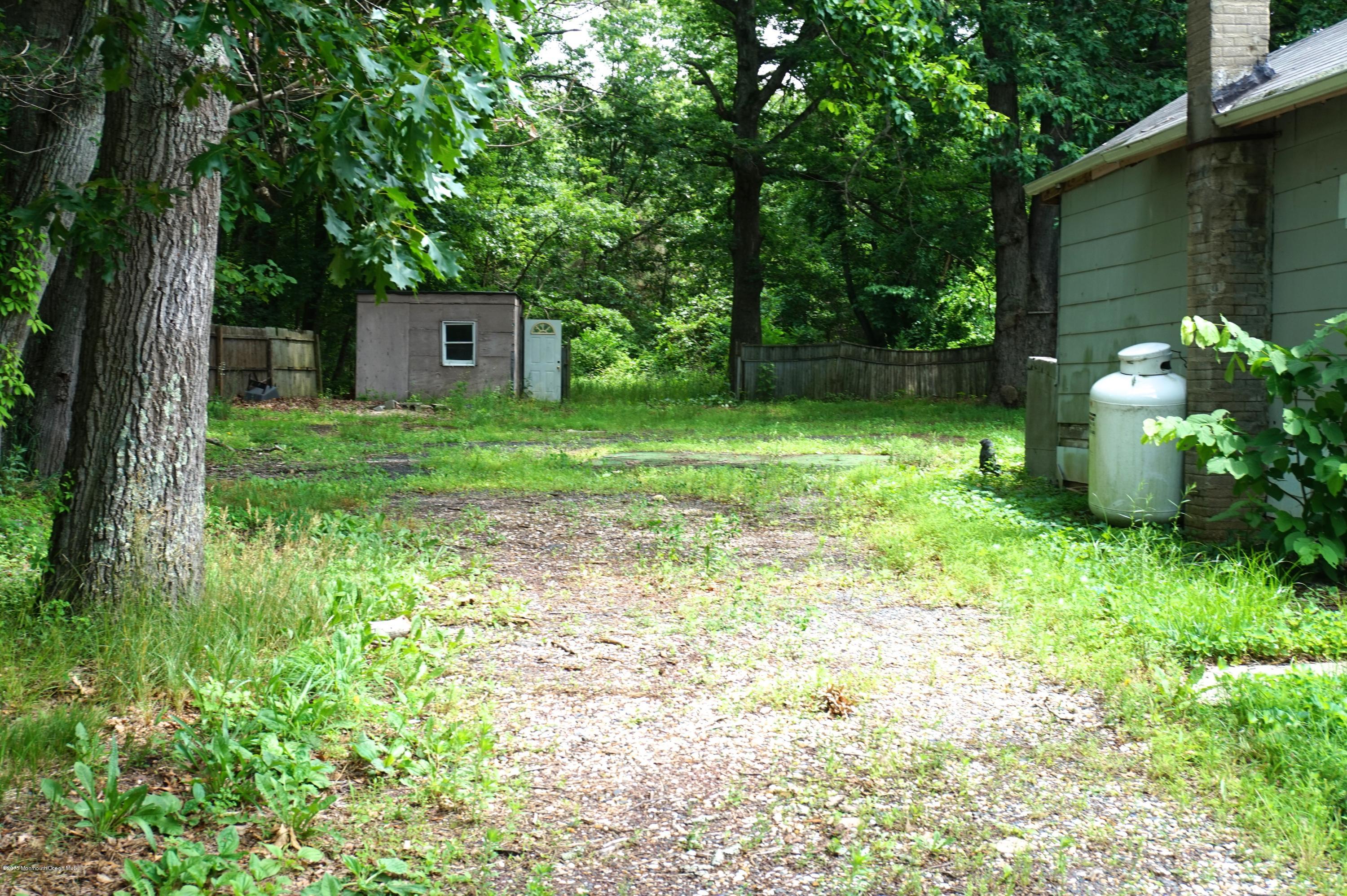 75 Siloam Road Freehold, NJ 07728 - Photo 5 of 9 a backyard of a house with lots of green space
