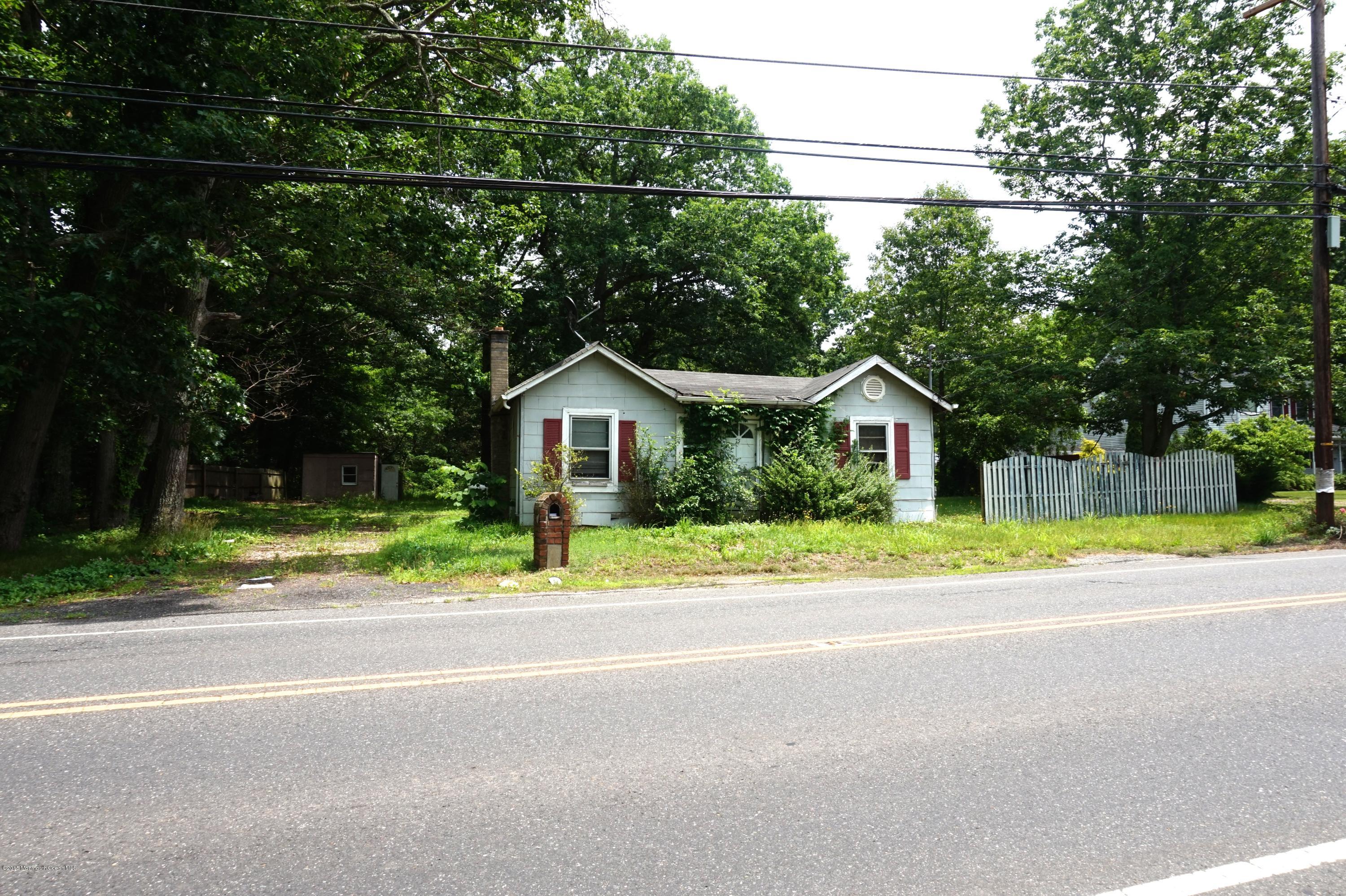 75 Siloam Road Freehold, NJ 07728 - Photo 7 of 9 a front view of a house with a yard and trees