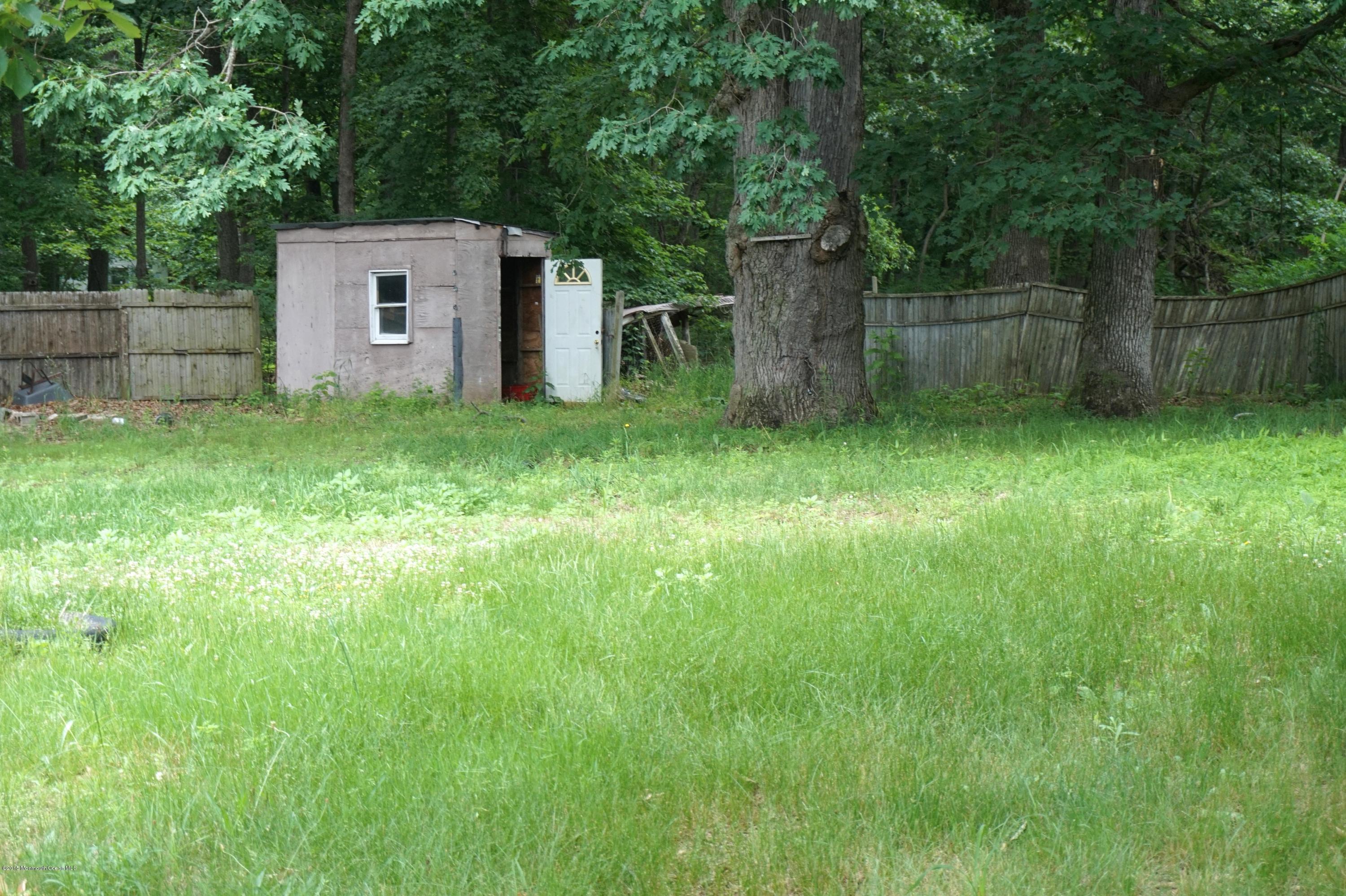 75 Siloam Road Freehold, NJ 07728 - Photo 9 of 9 a view of a backyard with large trees and plants