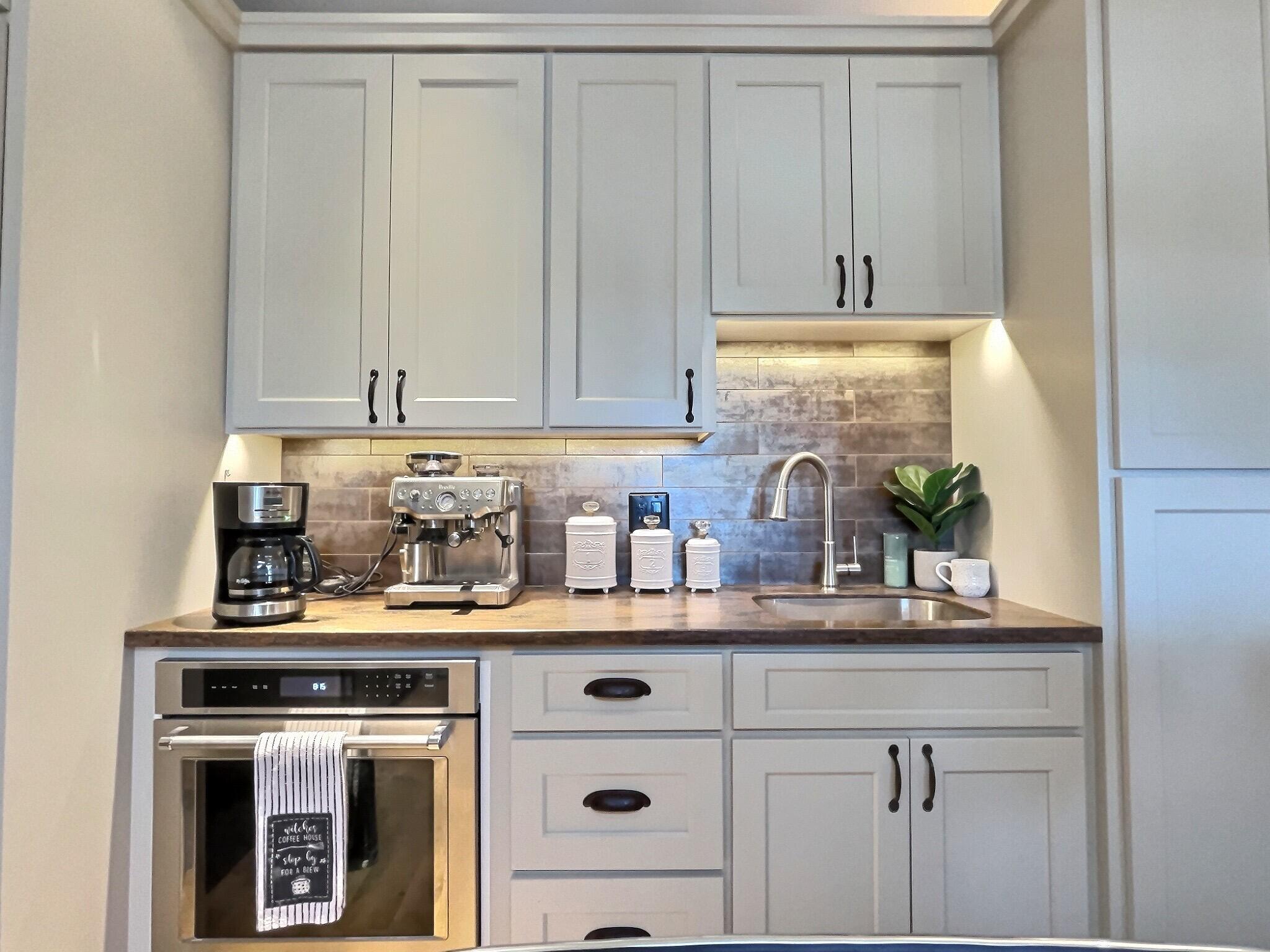 60360 Horse Butte Road Bend, OR 97702 - Photo 17 of 58 a kitchen with cabinets and white appliances