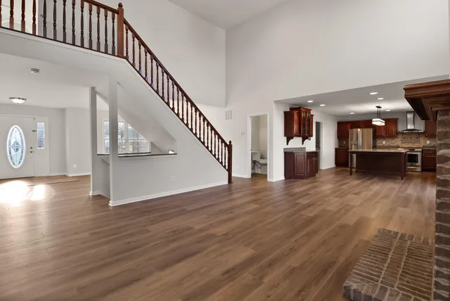 a view of entryway and hall with wooden floor