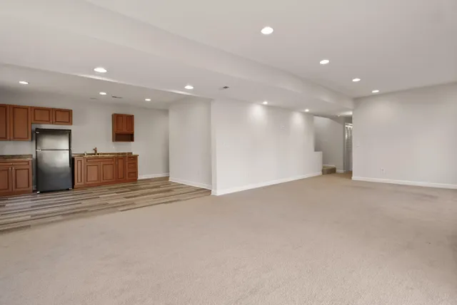 a kitchen with stainless steel appliances granite countertop a refrigerator sink and cabinets