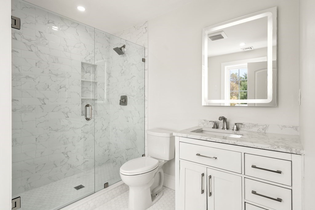15 Marcus Road Sharon, MA 02067 - Photo 18 of 21 a bathroom with a shower sink vanity mirror and toilet