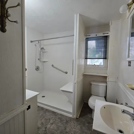 a view of a room with wooden floor and windows