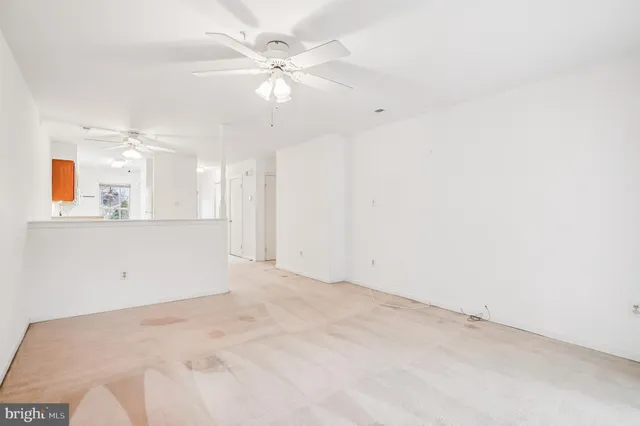 an empty room with a bathroom and a mirror