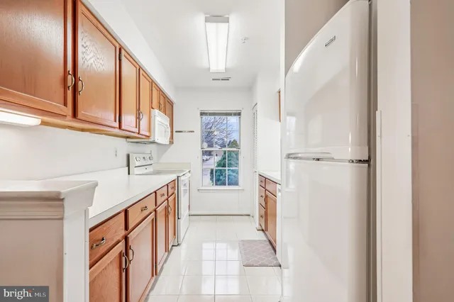 a kitchen with a refrigerator a sink and cabinets