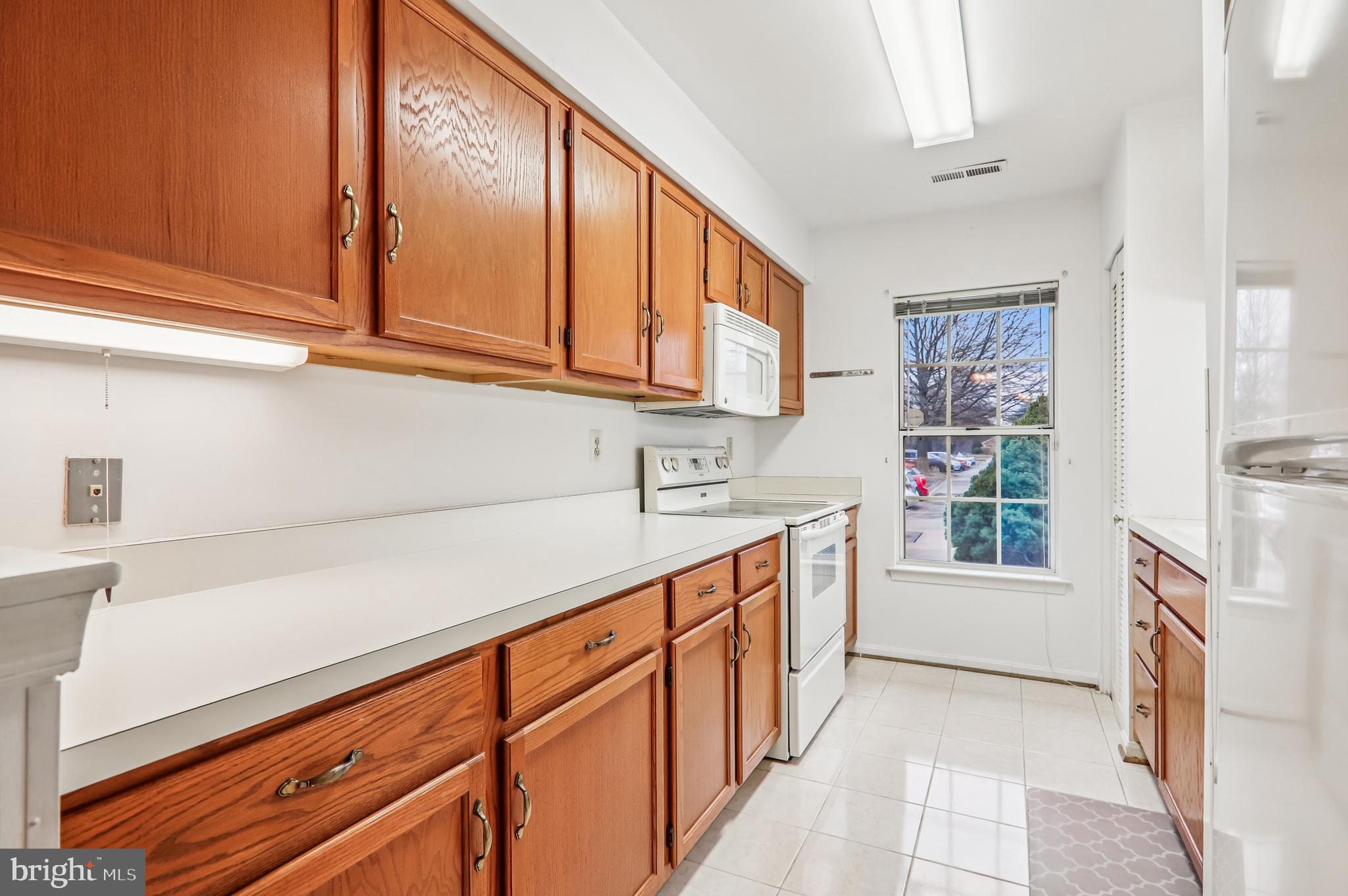9272 Cherry Lane, Unit 75 Laurel, MD 20708 - Photo 17 of 37 a kitchen with stainless steel appliances granite countertop a refrigerator and a stove top oven