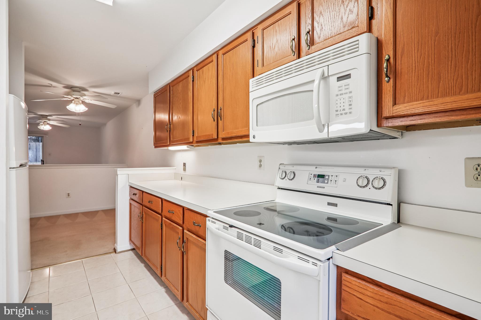9272 Cherry Lane, Unit 75 Laurel, MD 20708 - Photo 19 of 37 a kitchen with a sink stove and cabinets